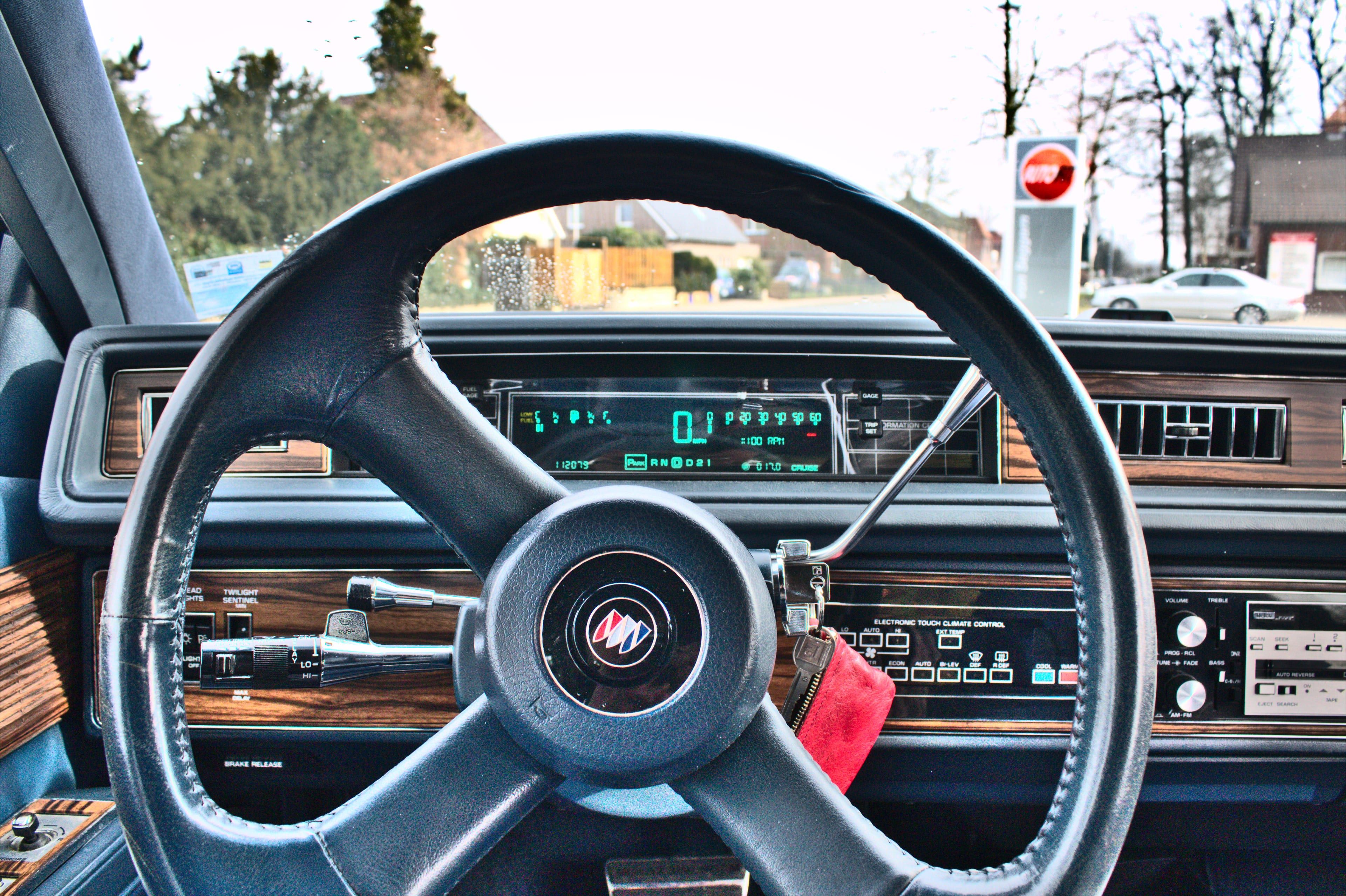A glowing green digital speedometer and trip readout in a 1989 Buick dashboard