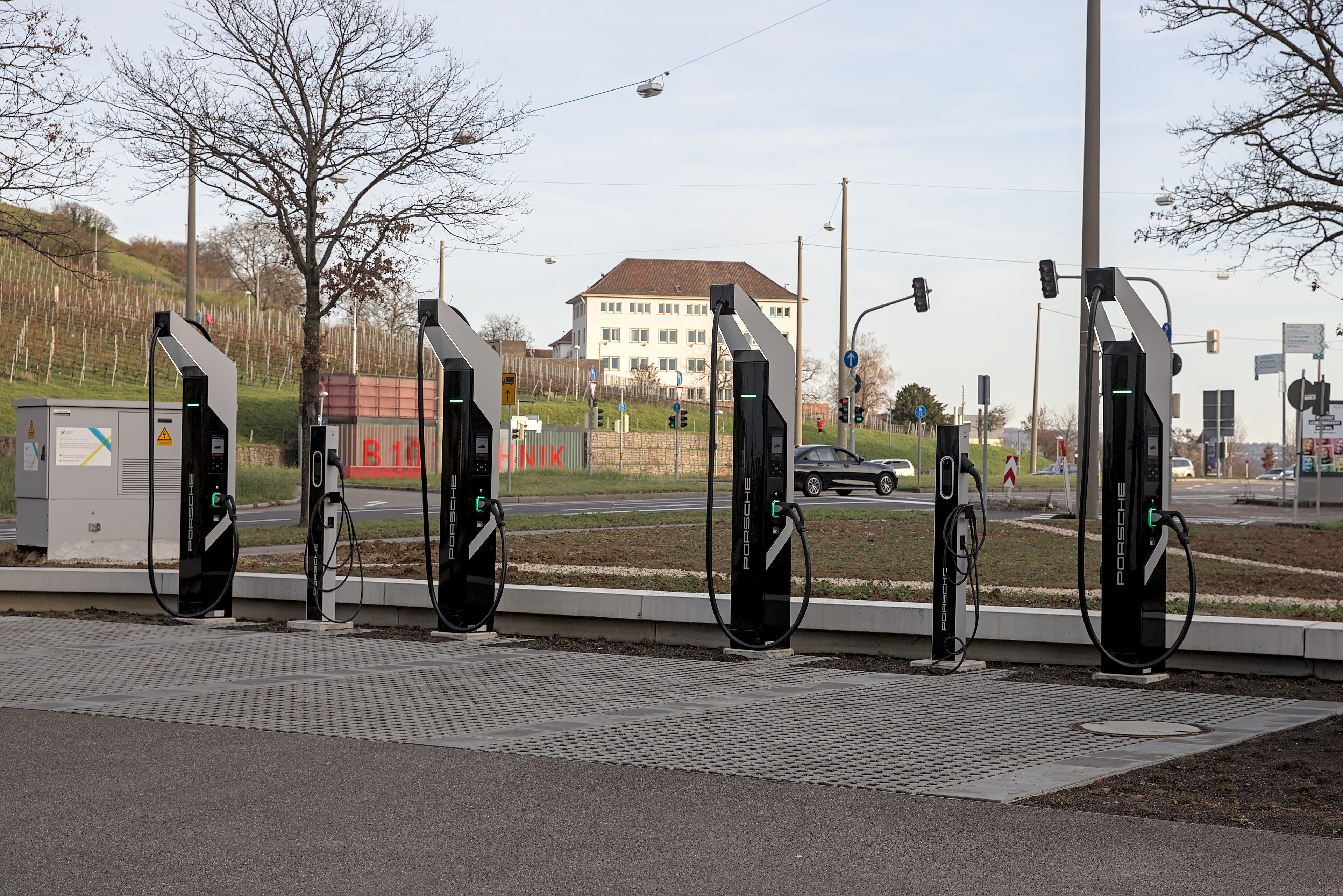 A row of electric vehicle fast chargers beside a road